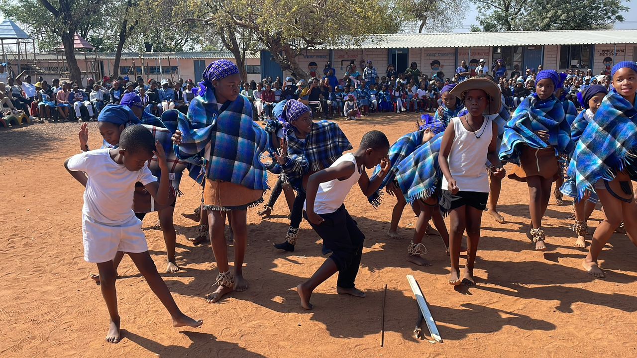 School learners engaged in traditional dance performance celebrating culture and heritage